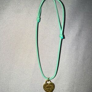 Tiffany and Co 18 K Gold Pendant on Turquoise Cord bracelet